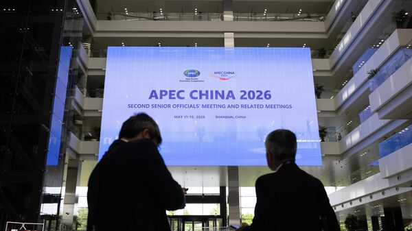 People walk in Shanghai Expo Center ahead of the opening session of the APEC China 2026 second Ssnior officials' meeting, in Shanghai, China, Monday, May 18, 2026. - Sputnik भारत