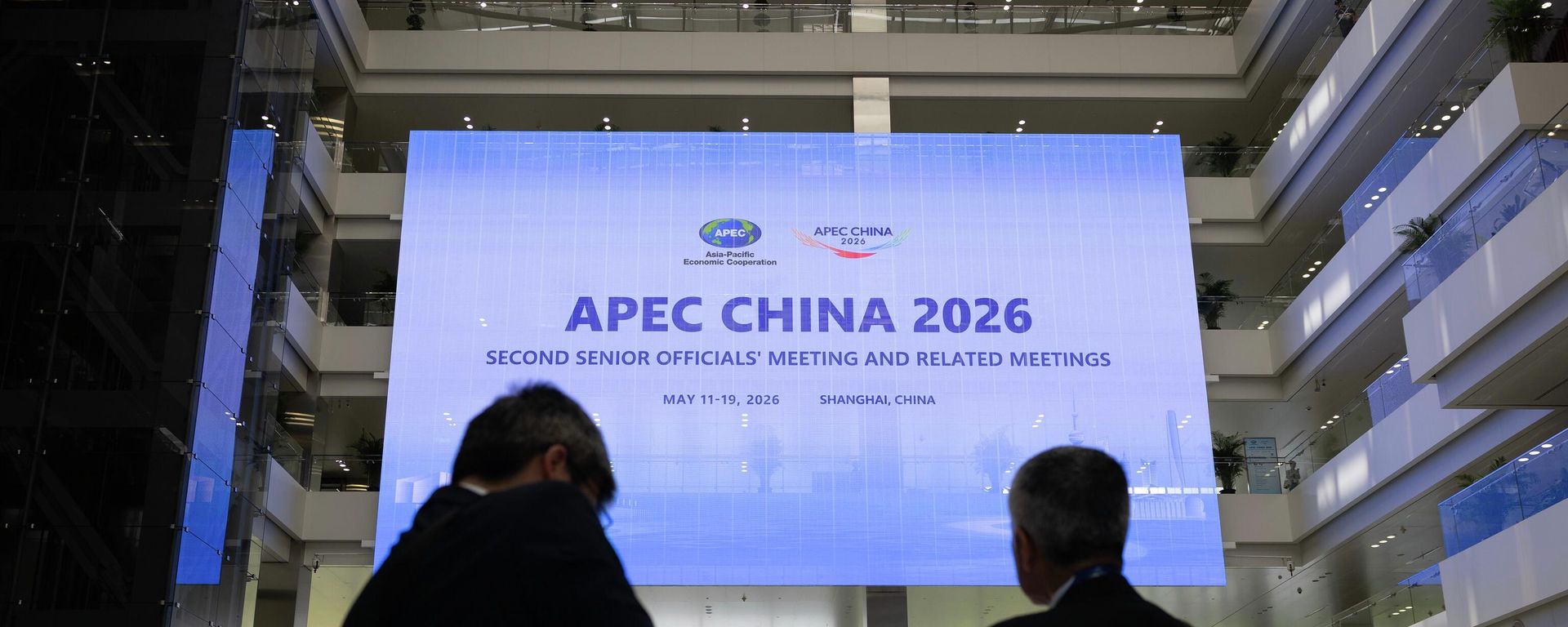 People walk in Shanghai Expo Center ahead of the opening session of the APEC China 2026 second Ssnior officials' meeting, in Shanghai, China, Monday, May 18, 2026. People walk in Shanghai Expo Center ahead of the opening session of the APEC China 2026 second Ssnior officials' meeting, in Shanghai, China, Monday, May 18, 2026. - Sputnik India, 1920, 02.10.2026