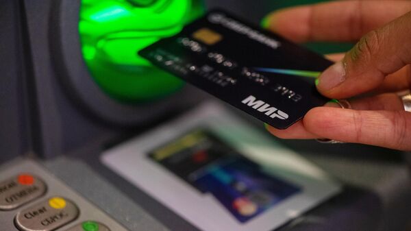 A MIR bank card is seen being used in Yerevan, Armenia. File photo - Sputnik India