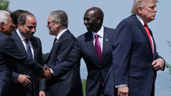 US President Donald Trump, European Council President Antonio Costa, Egyptian President Abdel Fattah al-Sisi, Kenya's President William Ruto and British Prime Minister Keir Starmer attend a family photo session during the G7 summit in France on June 16, 2026.  - Sputnik India
