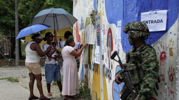 Voters check electoral lists during the runoff presidential election in Jamundi, Colombia - Sputnik India