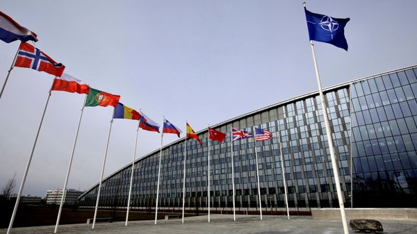 Flags of Alliance members flap in the wind outside NATO headquarters in Brussels, Friday, Feb. 28, 2020.  - Sputnik भारत