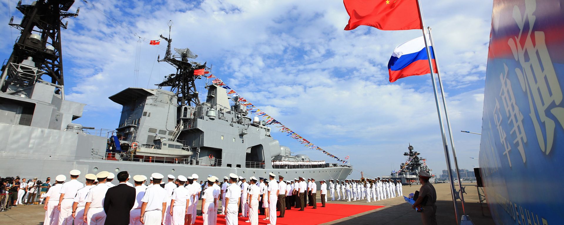 In this photo released by China's Xinhua News Agency, officers and soldiers of China's People's Liberation Army (PLA) Navy hold a welcome ceremony as a Russian naval ship arrives in port in Zhanjiang in southern China's Guangdong Province, Monday, Sept. 12, 2016 - Sputnik India, 1920, 05.07.2026