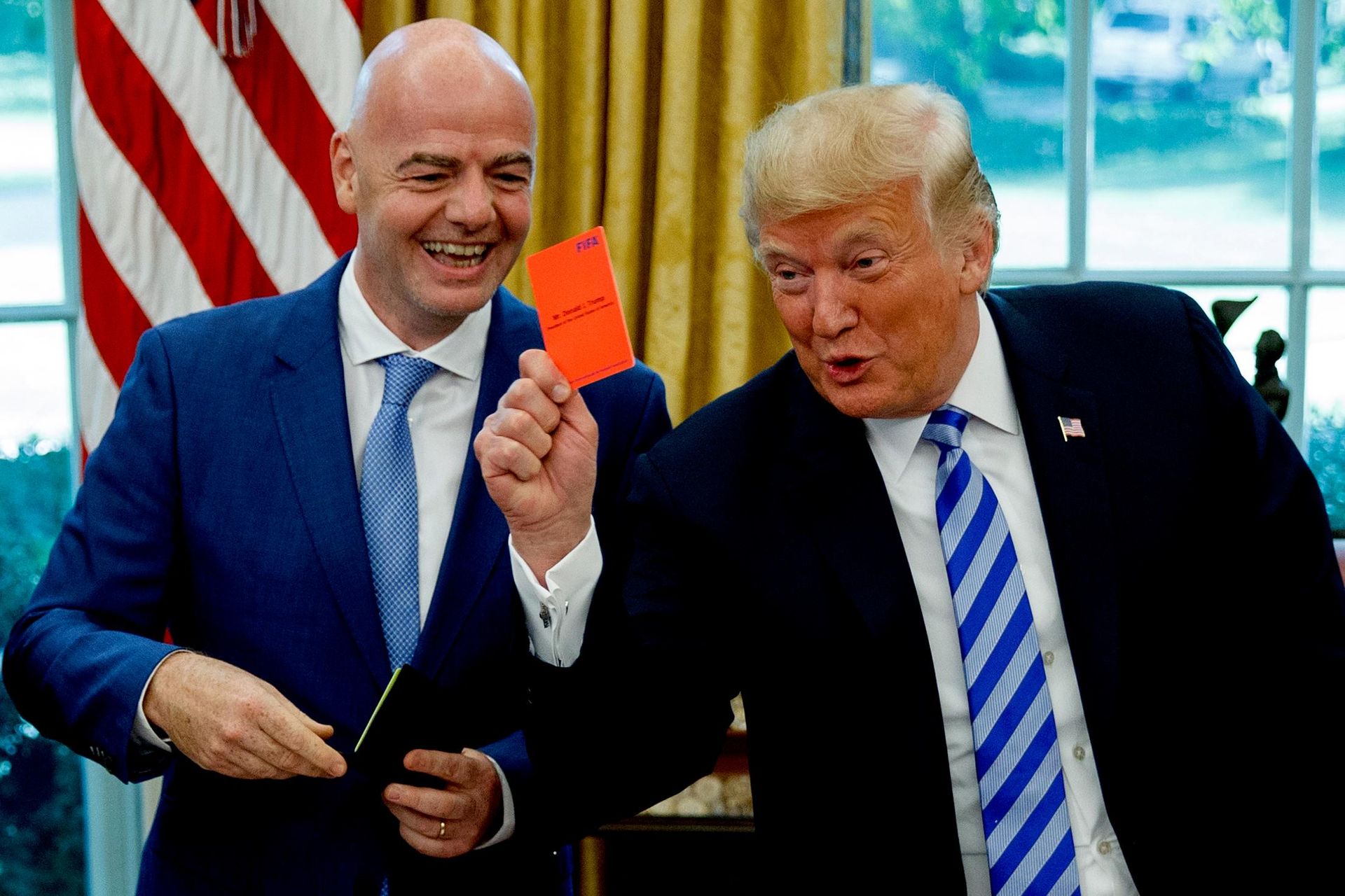 President Donald Trump holds up a red card during a meeting with FIFA president Gianni Infantino in the Oval Office of the White House, Tuesday, Aug. 28, 2018, in Washington.  - Sputnik India, 1920, 09.07.2026