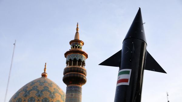 A model of a missile is carried by Iranian demonstrators as a minaret and dome of a mosque is seen at background during an anti-Israeli gathering at the Felestin (Palestine) Sq. in Tehran, Iran - Sputnik India