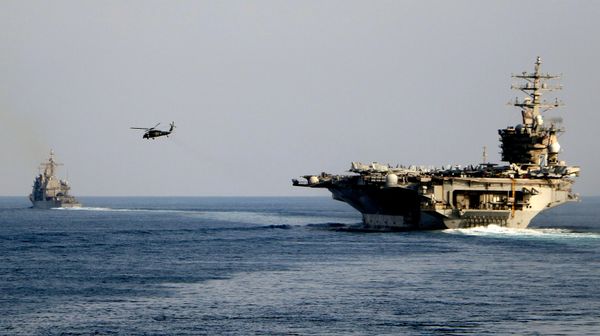 The aircraft carrier USS Dwight D. Eisenhower and other warships crosses the Strait of Hormuz into the Persian Gulf on Sunday, Nov. 26, 2023 - Sputnik India