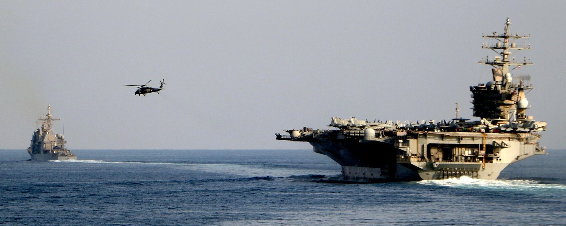 The aircraft carrier USS Dwight D. Eisenhower and other warships crosses the Strait of Hormuz into the Persian Gulf on Sunday, Nov. 26, 2023 - Sputnik India, 1920, 15.07.2026