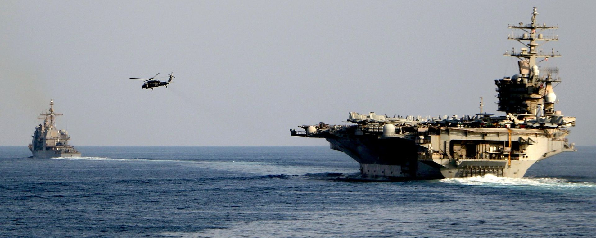 The aircraft carrier USS Dwight D. Eisenhower and other warships crosses the Strait of Hormuz into the Persian Gulf on Sunday, Nov. 26, 2023 - Sputnik भारत, 1920, 27.07.2026