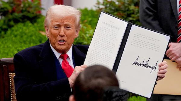 President Donald Trump holds a signed executive order during an event to announce new tariffs in the Rose Garden of the White House, Wednesday, April 2, 2025, in Washington - Sputnik India
