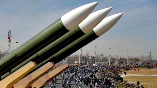 Iranians drive past missiles by their motorcycles during a rally marking the 42nd anniversary of the Islamic Revolution, at Azadi (Freedom) Square in Tehran, Iran, Wednesday, Feb. 10, 2021 - Sputnik भारत