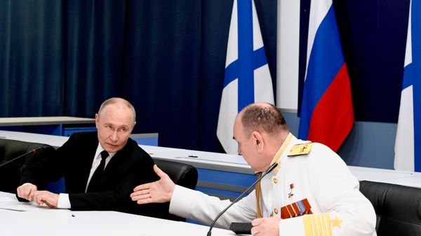 Russian President and Supreme Commander-in-Chief Vladimir Putin during a meeting with naval command at the Main Admiralty in St. Petersburg on Navy Day, July 26, 2026. Commander-in-Chief of the Russian Navy Alexander Moiseev is seen on the right. - Sputnik India