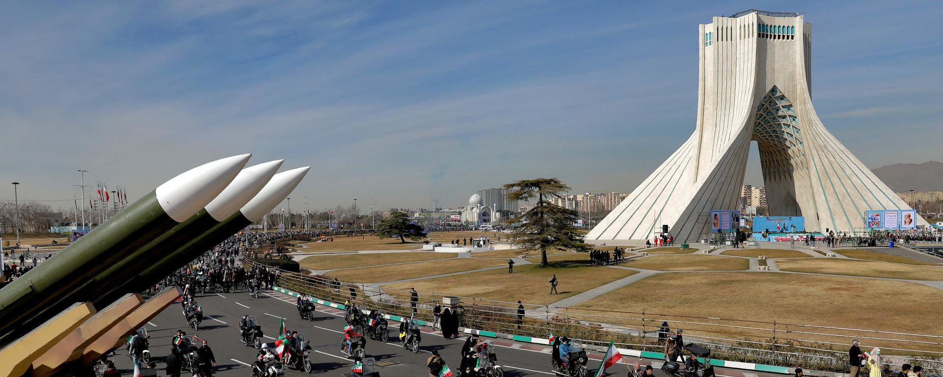 Iranians drive past missiles by their motorcycle during a rally marking the 42nd anniversary of the Islamic Revolution, at Azadi (Freedom) Square in Tehran, Iran, Wednesday, Feb. 10, 2021 - Sputnik भारत, 1920, 27.07.2026