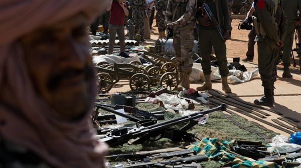 Malian soldiers look on as weapons, munitions, and other paraphernalia seized from radical Islamist militants are displayed at the French army base in Gao, Mali, Sunday, Feb. 24, 2013 - Sputnik भारत