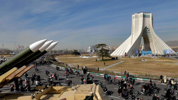 ranians drive past missiles by their motorcycle during a rally marking the 42nd anniversary of the Islamic Revolution, at Azadi (Freedom) Square in Tehran, Iran, Wednesday, Feb. 10, 2021 - Sputnik India