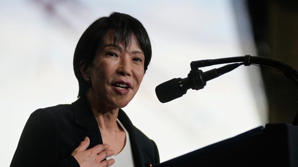 Japanese Prime Minister Sanae Takaichi, with President Donald Trump, speaks to members of the military aboard the USS George Washington, an aircraft carrier docked at a U.S. naval base, in Yokosuka, south of Tokyo, Tuesday, Oct. 28, 2025. (AP Photo/Mark Schiefelbein) - Sputnik India