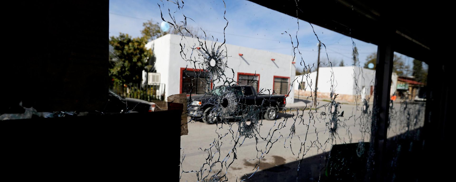 A shop's windows are riddled with bullets near City Hall after a gun battle between a heavily armed drug cartel assault group and security forces in Villa Union, Mexico, near the border with the U.S., Dec. 2, 2019. - Sputnik भारत, 1920, 17.08.2026