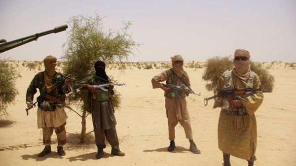 In this Tuesday, April 24, 2012 file photo, fighters from Islamist group Ansar Dine stand guard during a hostage handover, in the desert outside Timbuktu, Mali.   - Sputnik India