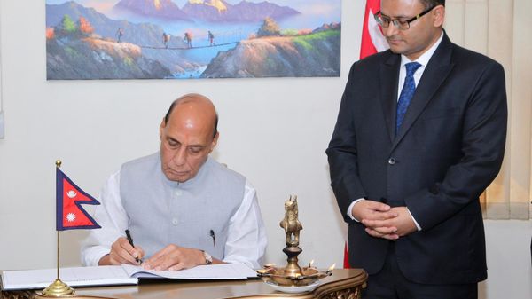 Indian Defence Minister Rajnath Singh signs the condolence book at the Embassy of Nepal in New Delhi. - Sputnik भारत