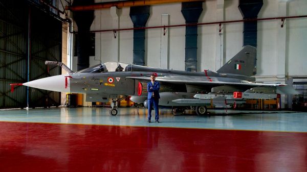 HAL Chairman and Managing Director Ravi K. with a Tejas fighter aircraft in the background. - Sputnik भारत