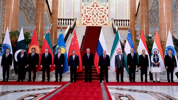 SCO Secretary-General Nurlan Yermekbayev, Pakistani Deputy Prime Minister and Foreign Minister Mohammad Ishaq Dar, Kyrgyz First Deputy Prime Minister Daniyar Amangeldiev, Belarusian Prime Minister Alexander Turchin, Kazakh Prime Minister Olzhas Bektenov, Chinese Premier Li Qiang, Tajik President Emomali Rahmon, Russian Prime Minister Mikhail Mishustin, Iranian First Vice President Mohammad Reza Aref, Uzbek Prime Minister Abdulla Aripov, Tajik Prime Minister Kokhir Rasulzoda, Indian Defense Minister Rajnath Singh and SCO Regional Anti-Terrorist Structure (RATS) Executive Committee Director Ularbek Sharsheev pose for a photo prior to a meeting of the Council of the Shanghai Cooperation Organization (SCO) Council of Heads of Government in Dushanbe, Tajikistan, Tuesday, Oct. 20, 2026. - Sputnik India