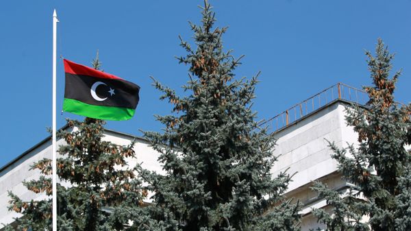 The flag of the National Transitional Council of Libya raised over the Libyan embassy in Moscow - Sputnik India